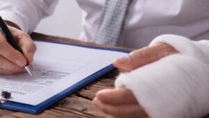 A man with an injured form reviewing legal forms