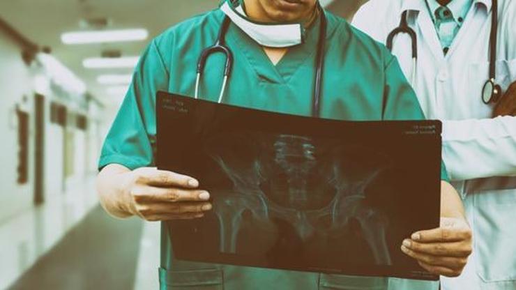 A medical professional reviewing an X-Ray.