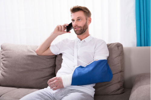 Man with broken arm calling Aiken personal injury lawyer.