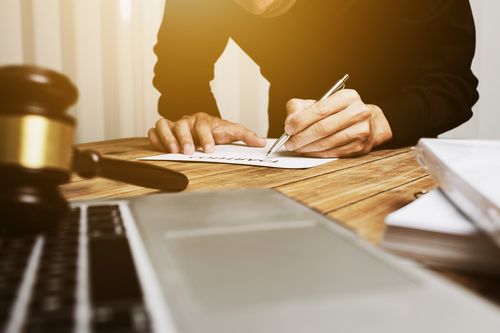 Image is of a Marietta personal injury lawyer working on a case at his desk